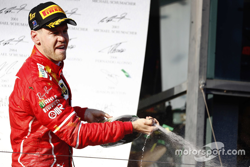 Sebastian Vettel, Ferrari, sprays the champagne on the podium after winning the race