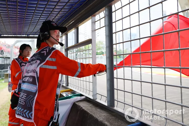 A marshal waves the red flag