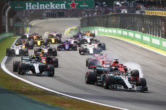 Lewis Hamilton, Mercedes AMG F1 W09 EQ Power+, leads Valtteri Bottas, Mercedes AMG F1 W09 EQ Power+, Sebastian Vettel, Ferrari SF71H, Kimi Raikkonen, Ferrari SF71H, Max Verstappen, Red Bull Racing RB14, and the rest of the field at the start