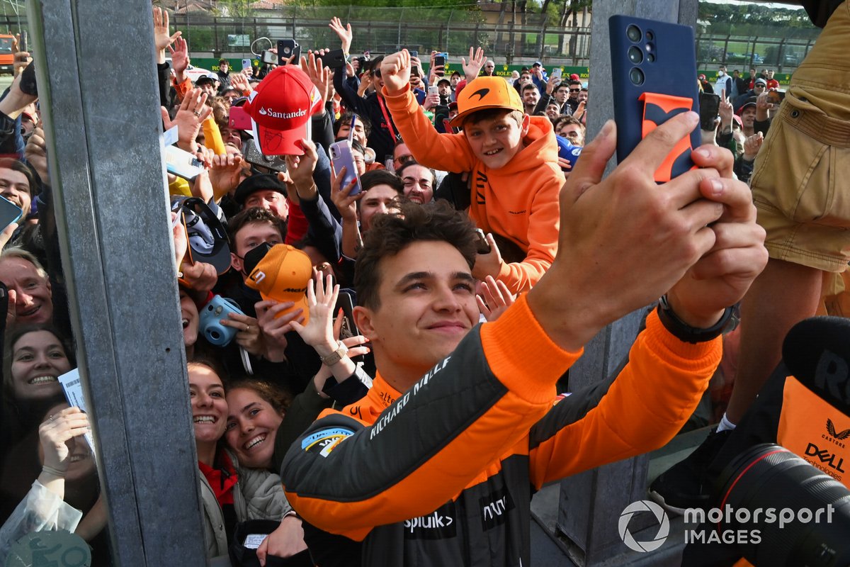 Lando Norris, McLaren, 3rd position, takes a selfie with fans