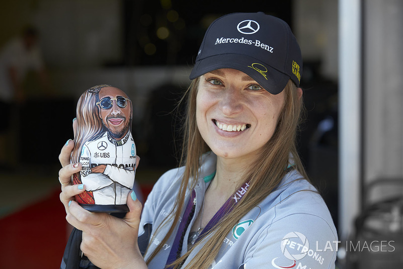 A Mercedes fan holds a Lewis Hamilton matryoshka figurine doll