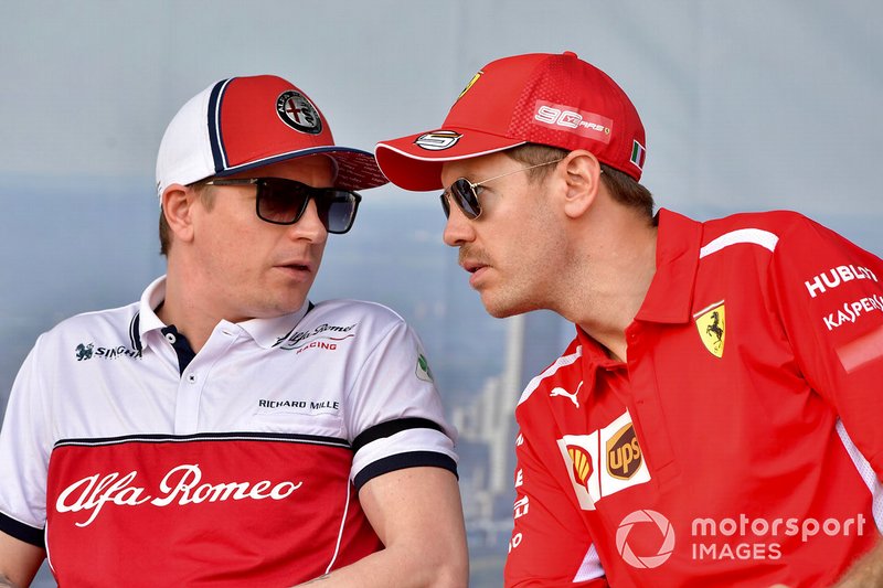 Kimi Raikkonen, Alfa Romeo Racing, and Sebastian Vettel, Ferrari, talk on stage