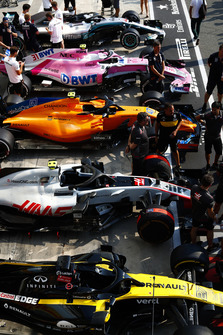 Cars of Nico Hulkenberg, Renault Sport F1 Team RS 18, Kevin Magnussen, Haas F1 Team VF-18, Lando Norris, McLaren MCL33, Esteban Ocon, Racing Point Force India VJM11, and Lewis Hamilton, Mercedes AMG F1 W09, line up in the pit lane