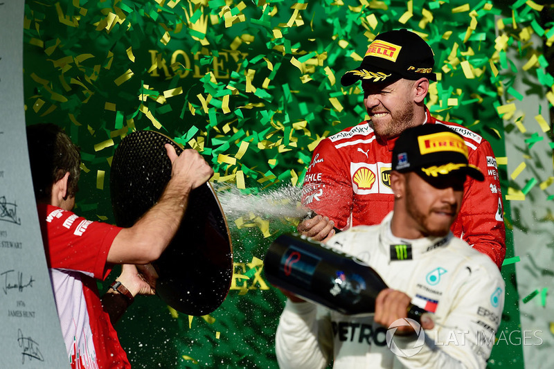 Lewis Hamilton, Mercedes-AMG F1 and Sebastian Vettel, Ferrari celebrate on the podium with the champ