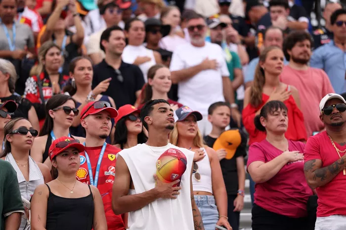 Fans stand during the national anthem.