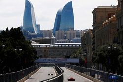 Felipe Massa, Williams FW40, Kimi Raikkonen, Ferrari SF70H, drive down opposing sides of a carriageway
