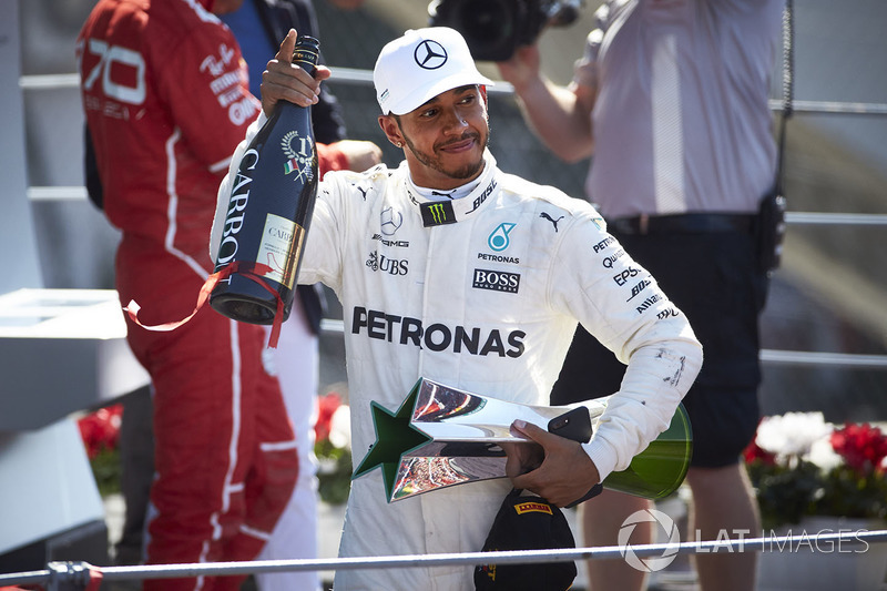 Race winner Lewis Hamilton, Mercedes AMG F1, leaves the podium, his trophy and Champagne