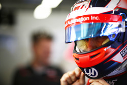 Romain Grosjean, Haas F1 Team, puts on his helmet in the garage