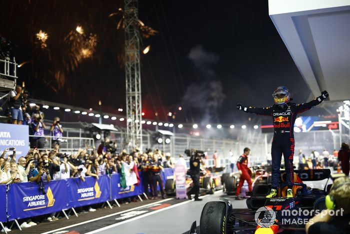 Los fuegos artificiales iluminan el cielo mientras Sergio Pérez, de Red Bull Racing, celebra su primera posición en el Parc Ferme