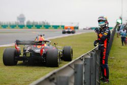 Daniel Ricciardo, Red Bull Racing, waits next to his stricken car
