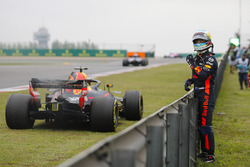 Daniel Ricciardo, Red Bull Racing, waits next to his stricken car