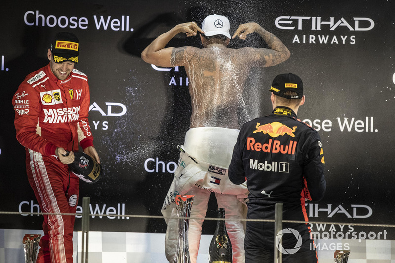 Sebastian Vettel, Ferrari, Lewis Hamilton, Mercedes AMG F1 and Max Verstappen, Red Bull Racing celebrate on the podium with the champagne 