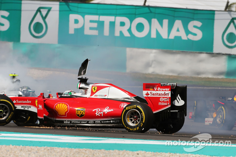 Sebastian Vettel, Ferrari SF16-H and Nico Rosberg, Mercedes AMG F1 W07 Hybrid collide at the start o