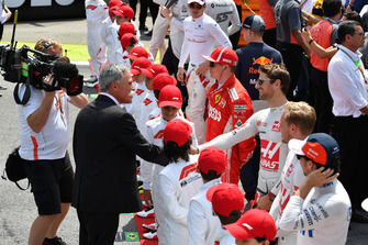 Chase Carey, Chief Executive Officer and Executive Chairman of the Formula One Group and Romain Grosjean, Haas F1 Team on the grid