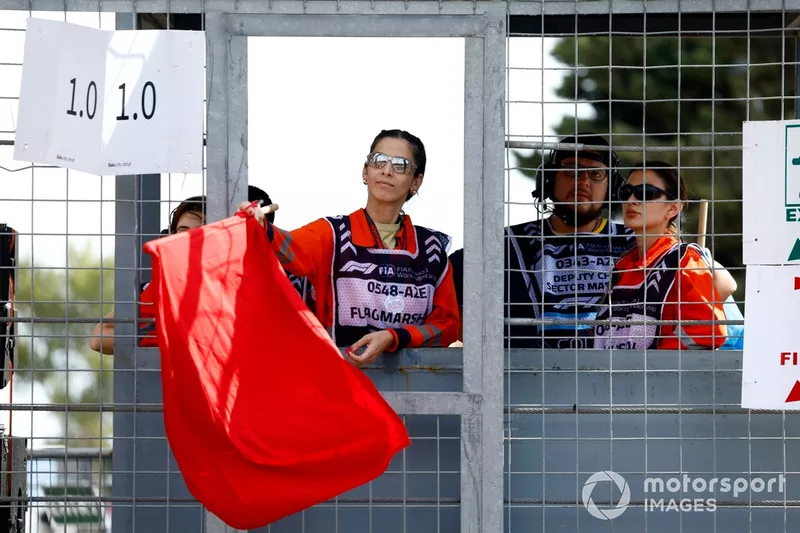A Marshal waves the red flag