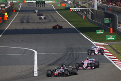 Romain Grosjean, Haas F1 Team VF-18 Ferrari,leads Esteban Ocon, Force India VJM11 Mercedes, and Sergio Perez, Force India VJM11 Mercedes