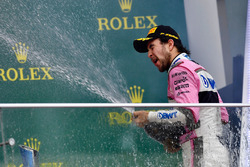 Third place Sergio Perez, Force India celebrates on the podium with the champagne