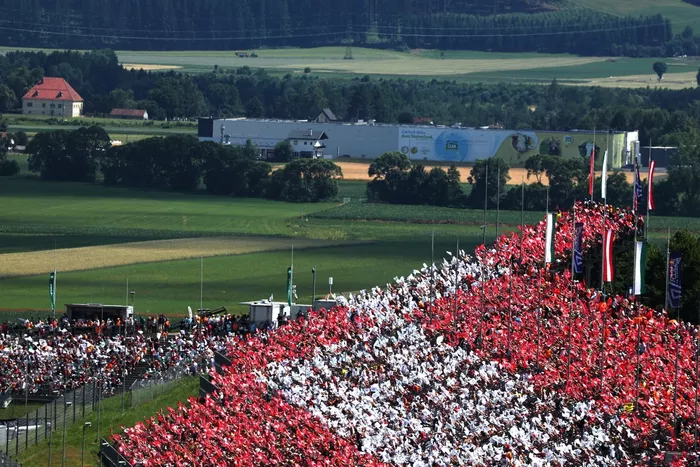 Fans make an Austrian flag tifo .