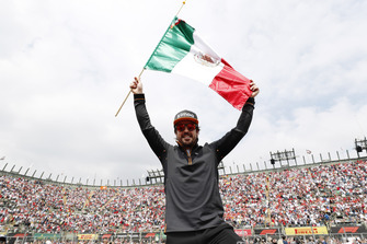 Fernando Alonso, McLaren, celebrates with a Mexican flag ahead of the race