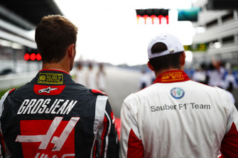 Romain Grosjean, Haas F1 Team, and Charles Leclerc, Sauber, on the grid for the national anthem