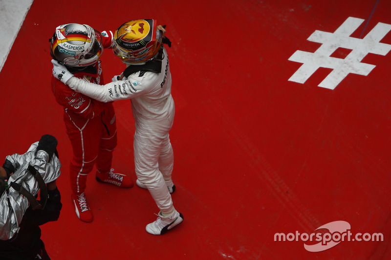 Lewis Hamilton, Mercedes AMG, and Sebastian Vettel, Ferrari, celebrate in parc ferme