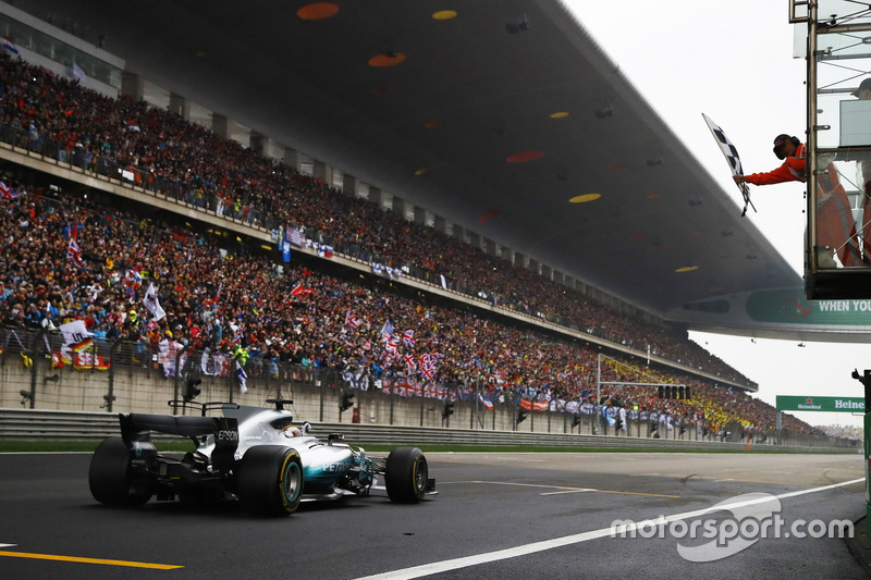 Lewis Hamilton, Mercedes AMG F1 W08, takes the chequered flag