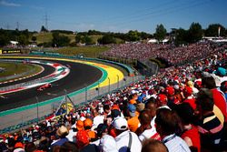 Fans watch Sebastian Vettel, Ferrari SF70H, lead Kimi Raikkonen, Ferrari SF70H