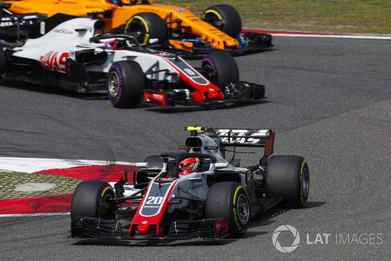 Kevin Magnussen, Haas F1 Team VF-18 Ferrari, leads Romain Grosjean, Haas F1 Team VF-18 Ferrari, and Fernando Alonso, McLaren MCL33 Renault