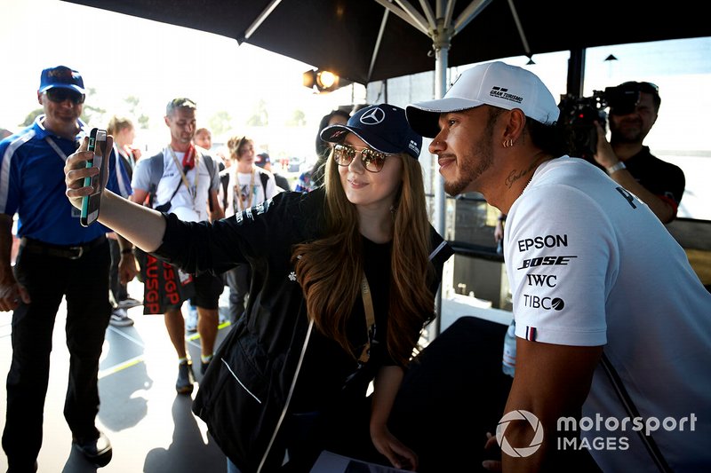 Lewis Hamilton, Mercedes AMG F1, takes as selfie with a fan