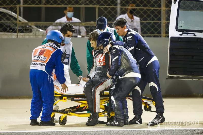 Medical delegates assist Romain Grosjean, Haas F1, after a huge crash on the opening lap