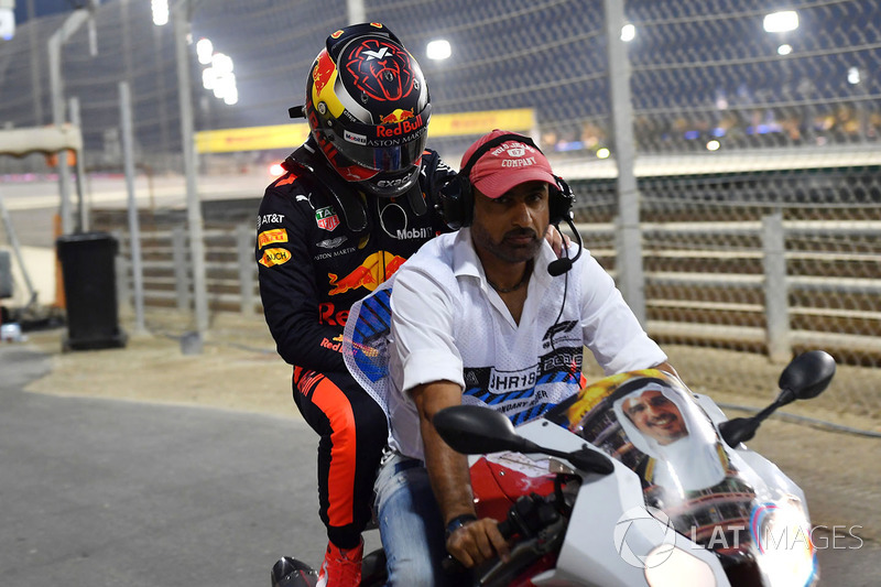 Max Verstappen, Red Bull Racing crashed in Q1 and is given a lift on a motorbike