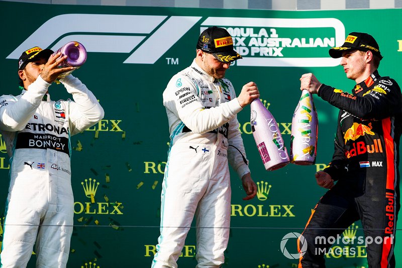 Lewis Hamilton, Mercedes AMG F1, 2nd position, Valtteri Bottas, Mercedes AMG F1, 1st position, and Max Verstappen, Red Bull Racing, 3rd position, celebrate with Champagne on the podium