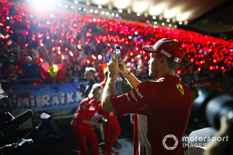 Sebastian Vettel, Ferrari, takes a photo of the gathered fans