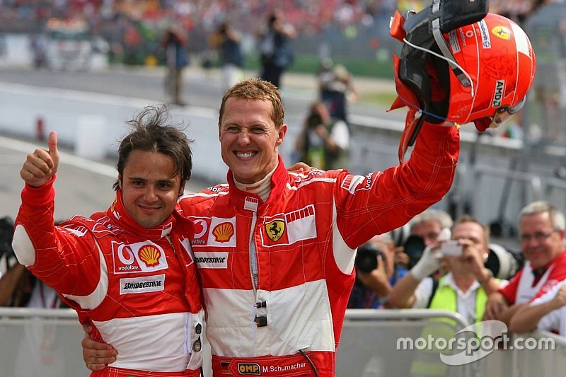 Race winner Michael Schumacher celebrates with Felipe Massa