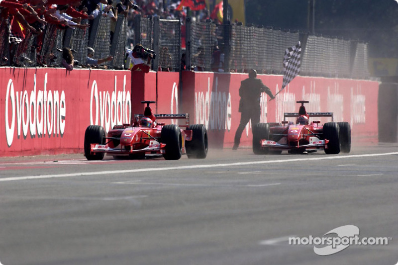 Rubens Barrichello taking the checkered flag in front of Michael Schumacher