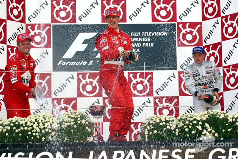 The podium: champagne for Michael Schumacher, Rubens Barrichello and Kimi Raikkonen