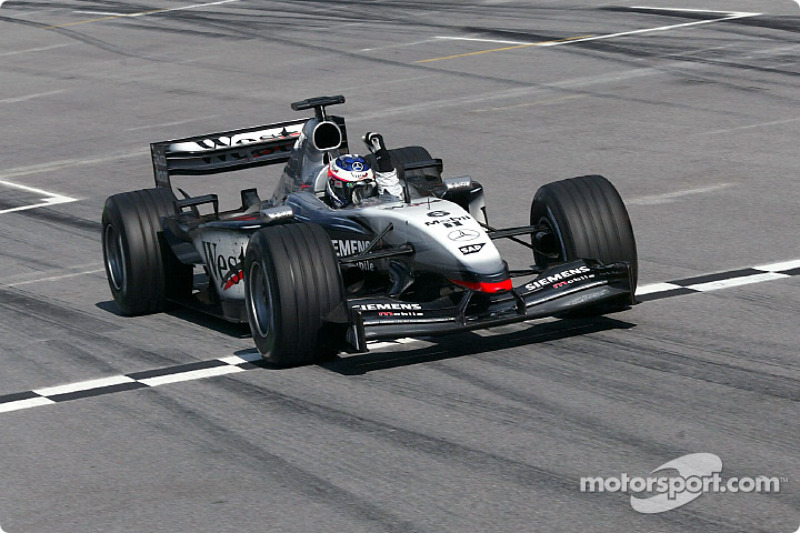 Kimi Raikkonen takes the checkered flag