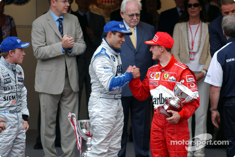 The podium: race winner Juan Pablo Montoya with Kimi Raikkonen and Michael Schumacher