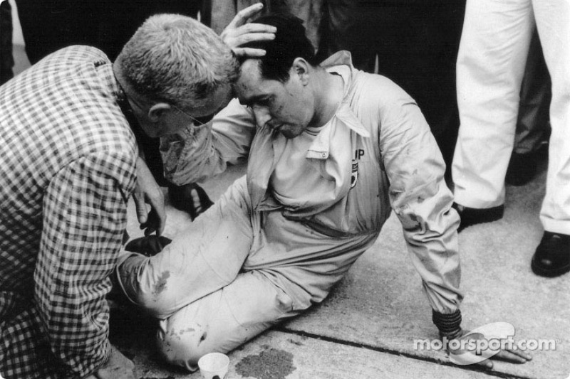 Jack Brabham takes a well-earned rest after pushing his Cooper-Climax half a mile to the finishing line