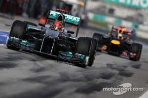 Michael Schumacher, Mercedes GP leads Sebastian Vettel, Red Bull Racing out of the pits