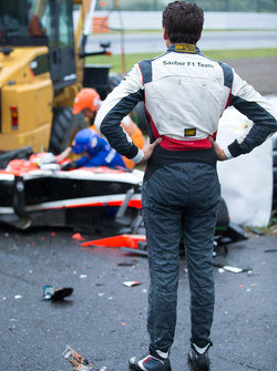 Adrian Sutil, Sauber F1 Team looks on as the safety team at work after the crash of Jules Bianchi, Marussia F1 Team