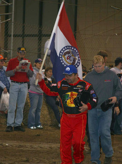 Danny Lasoski carries his state flag in pre race ceremonies