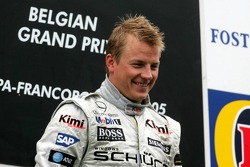 Podium: race winner Kimi Raikkonen celebrates