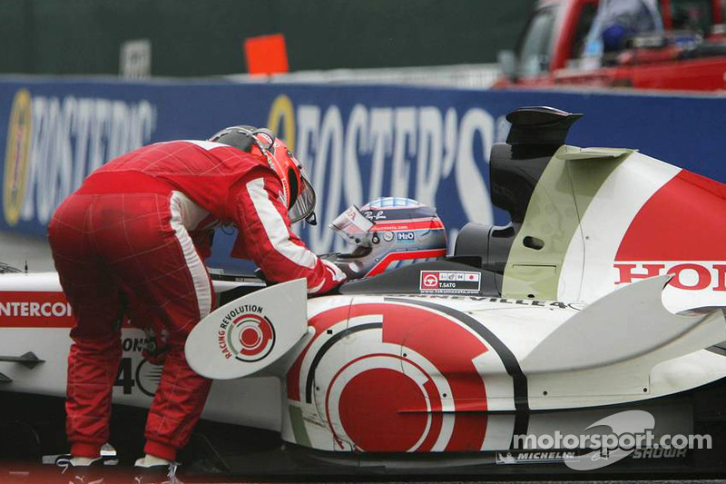 Michael Schumacher has a talk with Takuma Sato