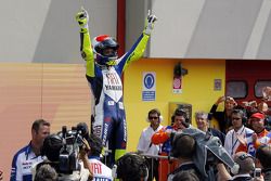 Race winner Valentino Rossi takes the checkered flag