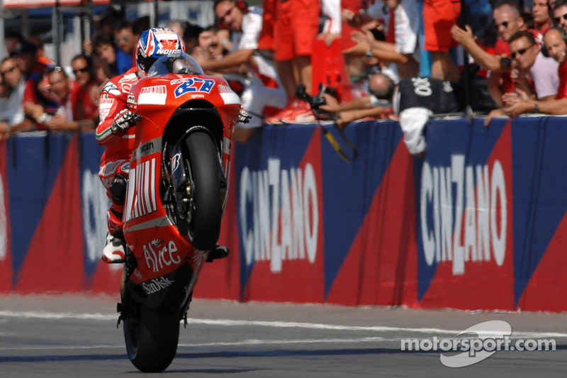 Casey Stoner takes the checkered flag