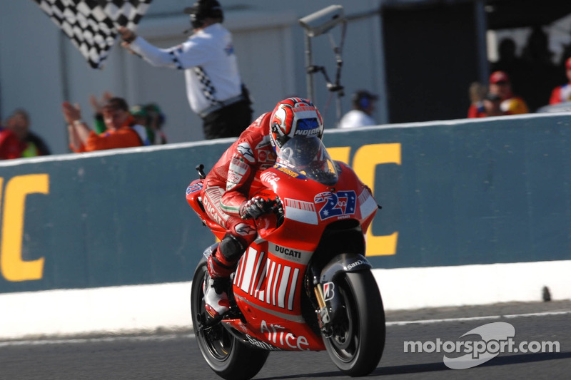 Casey Stoner takes the checkered flag