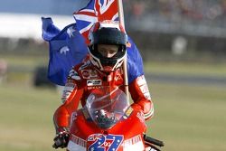 Race winner Casey Stoner celebrates