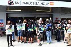 The media gather around the pit garage of Carlos Sainz Jr., Scuderia Toro Rosso in the third practice session